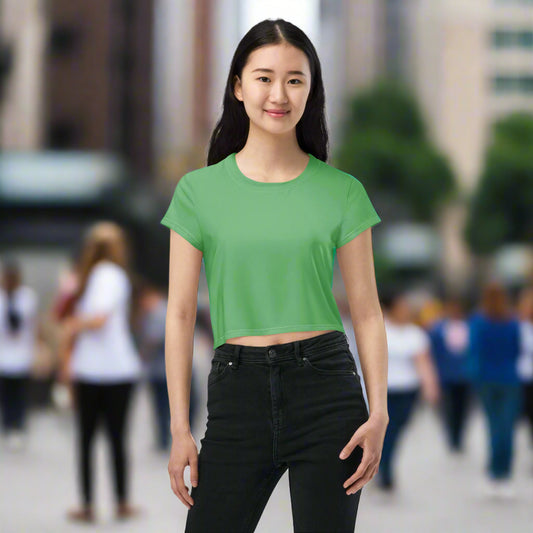 Woman wearing Emerald Energy Crop Tee in crowded city