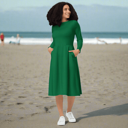 Front view of a woman wearing the Evergreen Elegance Midi Dress on a sunny beach.