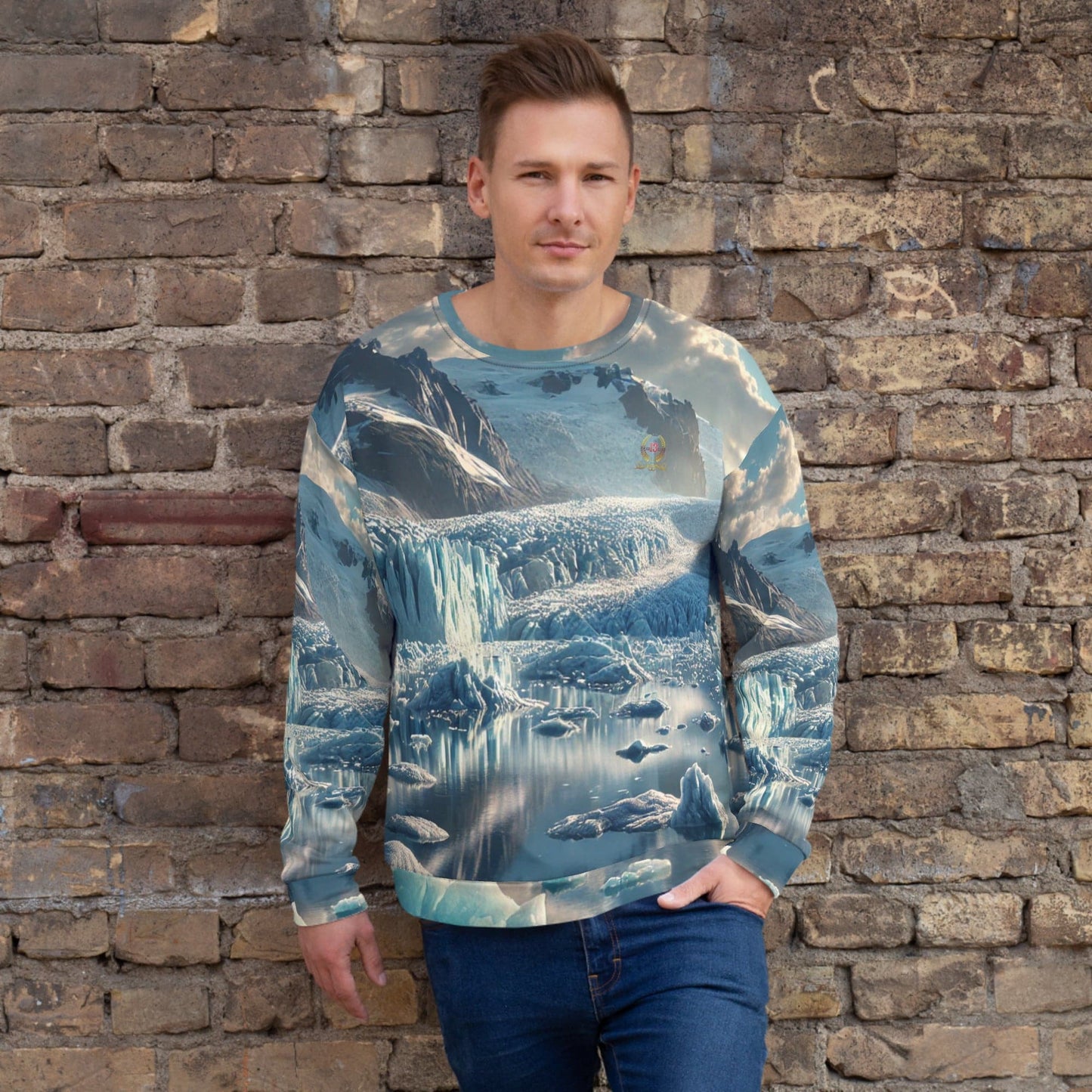 A man wearing the Glacier Majesty Sweatshirt, featuring an intricate glacier landscape, standing against a brick wall.