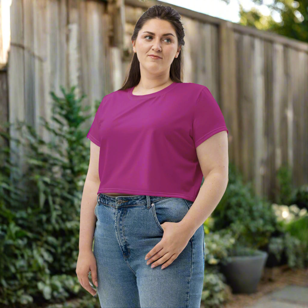 woman wearing Magenta Muse Crop Tee in her backyard front left view