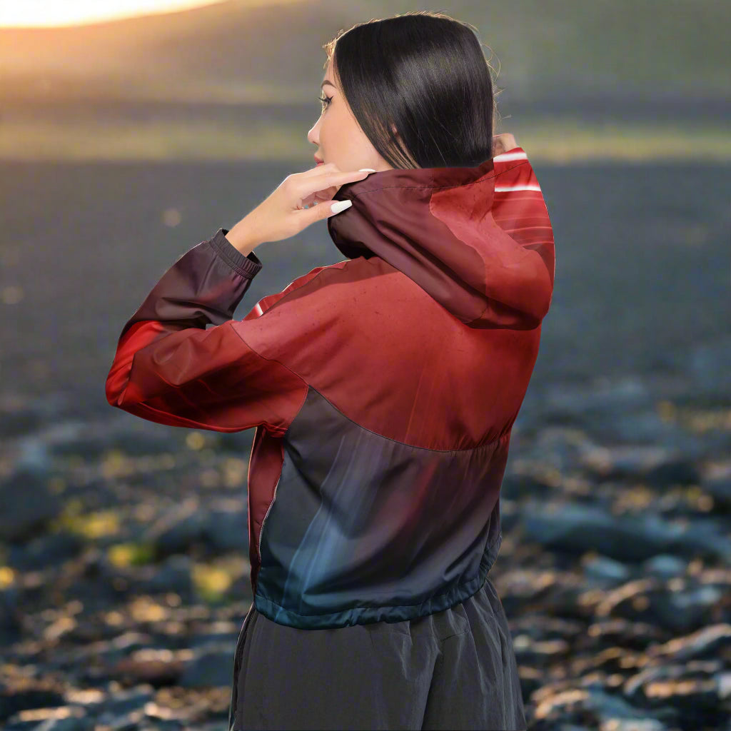 Woman putting hoodie on wearing The Adventurer's Cropped Windbreaker