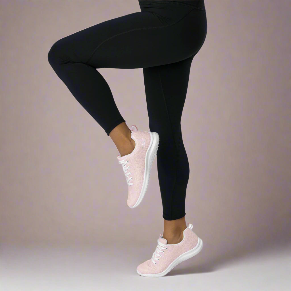 Woman doing knee lifts in The Blush Breeze Sneakers