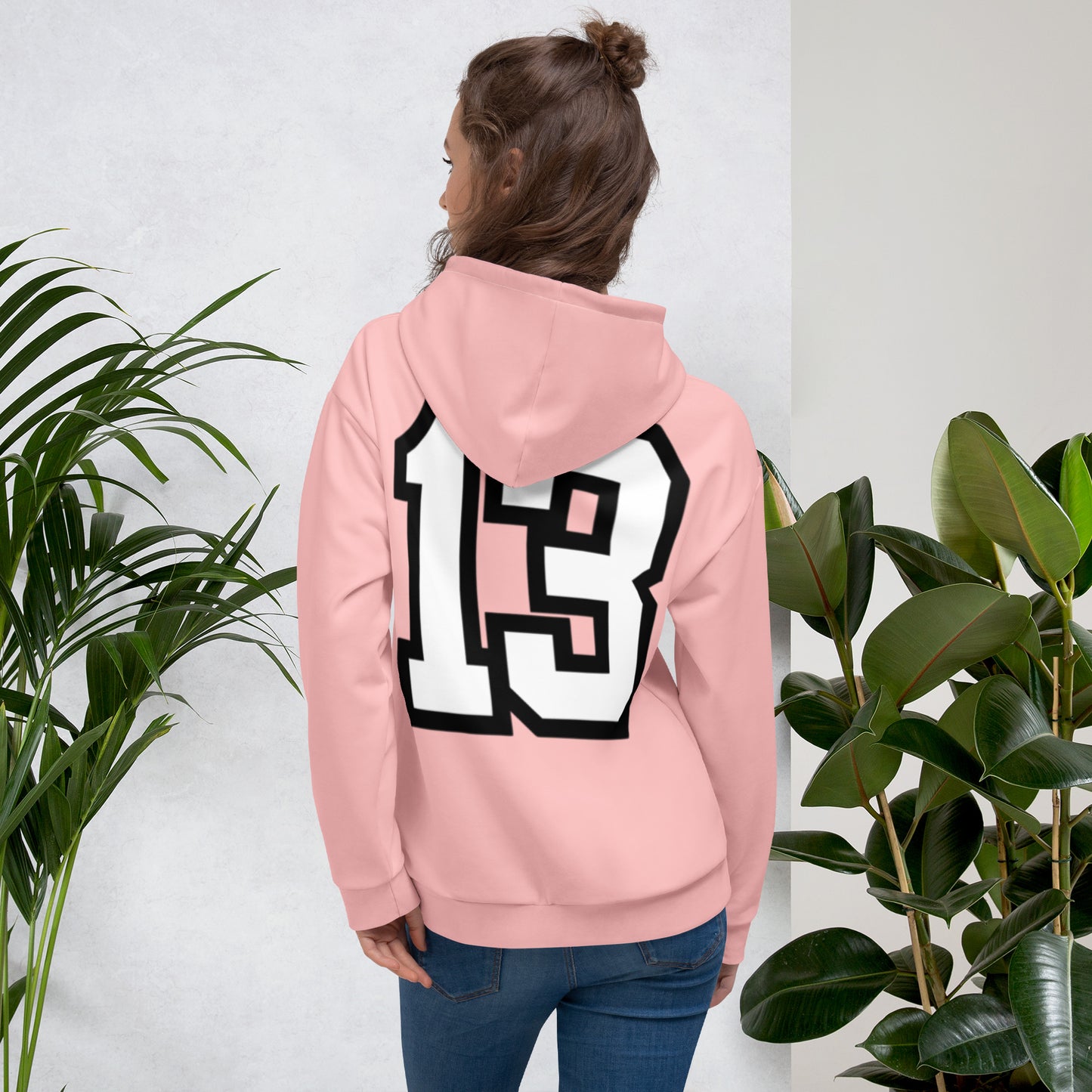 Woman wearing Thirteen Cozy Pink Unisex Hoodie back view