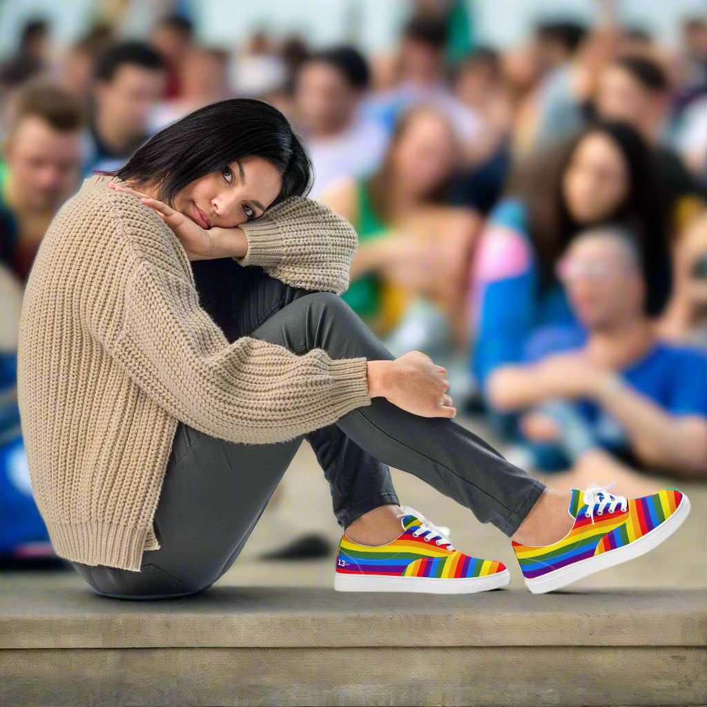 Woman sitting at a festival wearing Vivid Pride Lace-Ups