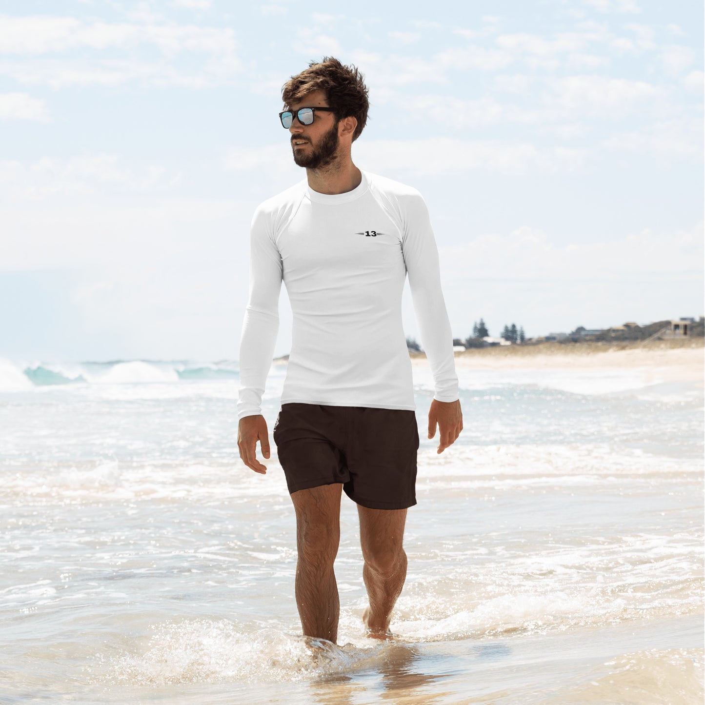 Man at the beach in White Rash Guard