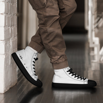 man standing against a wall in Men's High Top Canvas Sneakers black sole