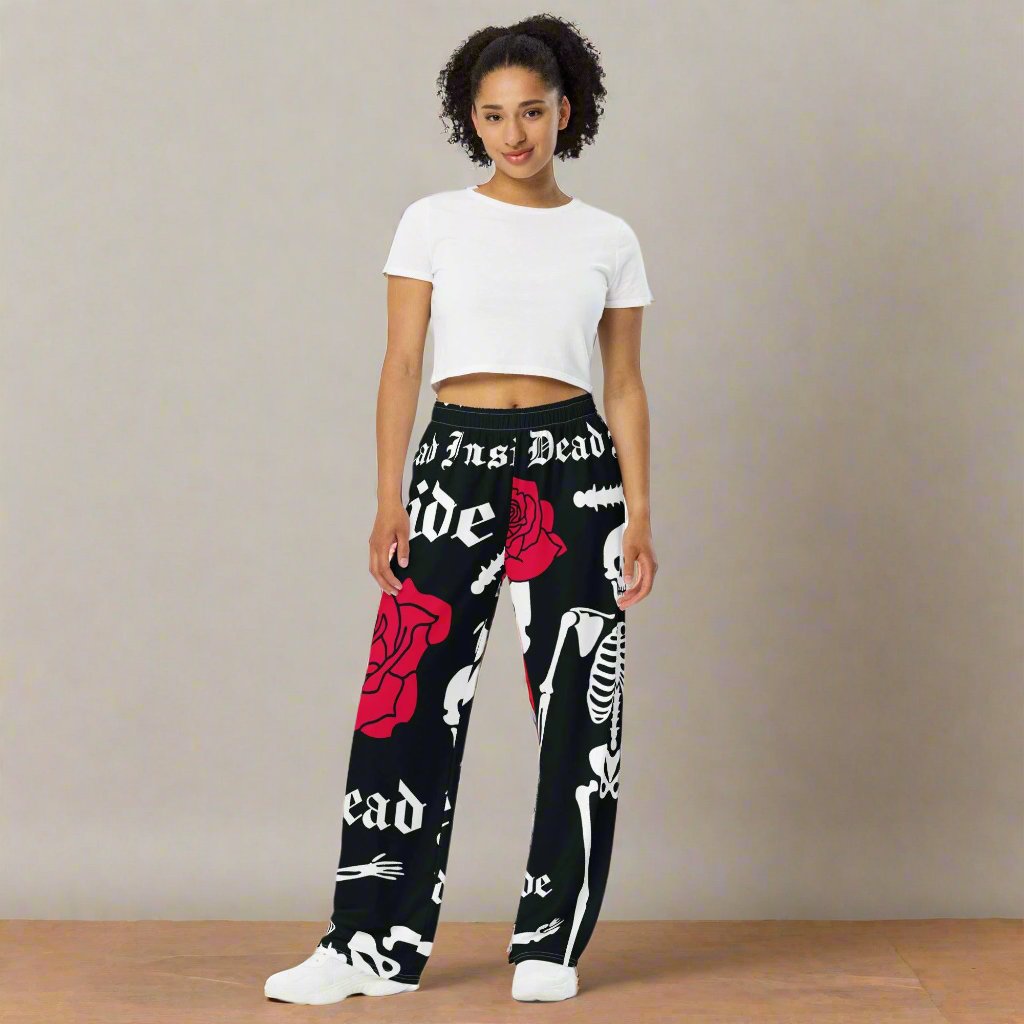 Unisex wide-leg lounge pants with black skeleton print - front view.